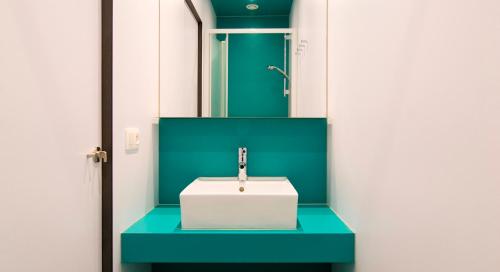 a bathroom with a sink and a mirror at Sleep Well Youth Hostel in Brussels