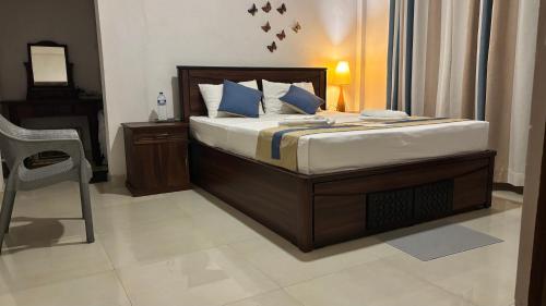 a bedroom with a bed with a chair and a piano at Chathu Holiday Home in Kandy