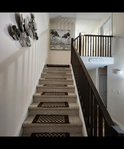 a staircase in a home with a stair case at Platinum Staycation EnSuite - Free Onsite Parking , Washroom Ensuite , Shared Full kitchen in London