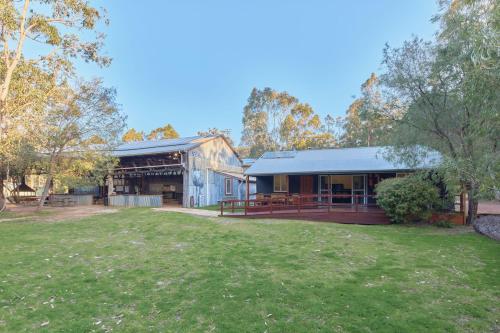 a building with a grass yard in front of it at RAC Margaret River Nature Park in Margaret River Town