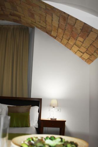 a room with a bed and a wooden beam at Roma Resort Colosseum in Rome