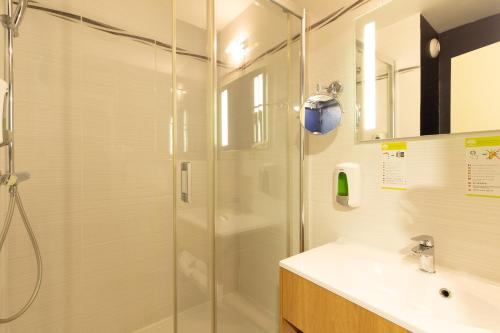 a bathroom with a shower and a sink at Logis Hôtel du Haut-Bugey in Oyonnax