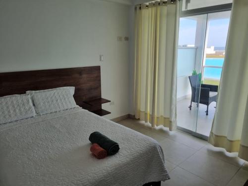 a bedroom with a bed with a towel on it at Casa de Playa Luxury Laguna Azul Tacna in Tacna