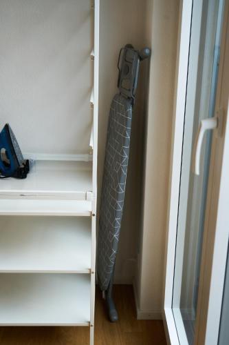 a tie hanging on a shelf in a closet at Duplex Apartment Bülach Station in Bülach