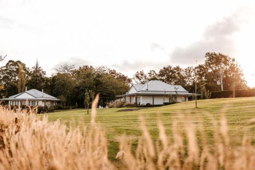 a house on a hill next to a field at The Homestead in Berry