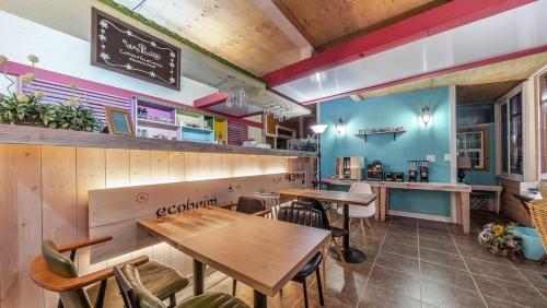 a restaurant with tables and chairs and a counter at Yangyang Hajodae Ecoheim Four Seasons Heated Pool N Spa Pension in Yangyang