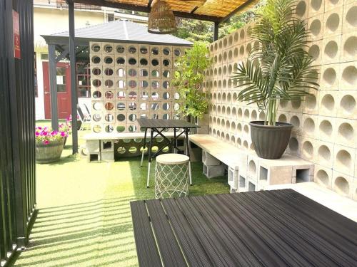 a patio with a table and a potted plant at Yangyang Hajodae Ecoheim Four Seasons Heated Pool N Spa Pension in Yangyang
