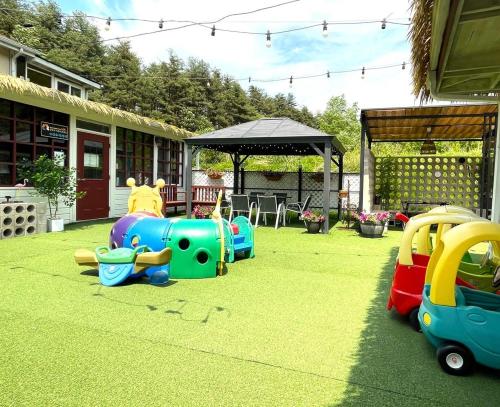 a childs play area with toy trains in a yard at Yangyang Hajodae Ecoheim Four Seasons Heated Pool N Spa Pension in Yangyang