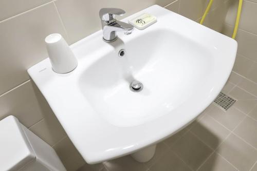 a bathroom with a white sink and a toilet at Hotel Stay Q Daejeon in Daejeon