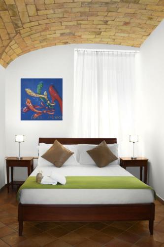 a bedroom with a large bed with a window at Roma Resort Colosseum in Rome