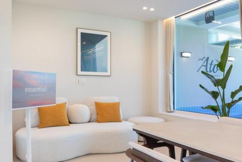 a living room with a white couch and a table at Gangneung Atopool Villa in Gangneung