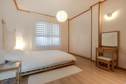 Postel nebo postele na pokoji v ubytování Jeju Broccoli BNB