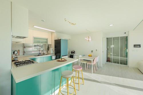 a kitchen with a counter and stools in a room at Yeoncheon Pension Nolmung dogs allowed in Yeoncheon