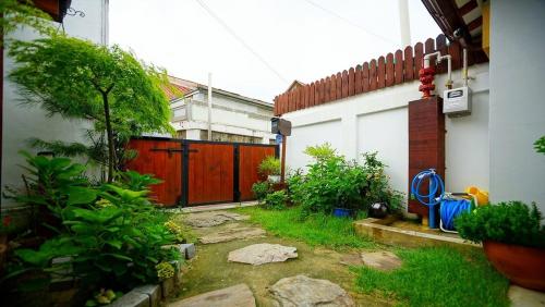 a backyard with a red fence and a gate at Haneulae Jeonju Hanok Village Accommodation in Jeonju