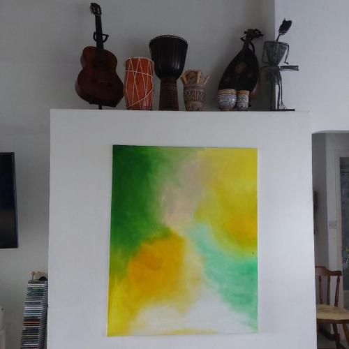 a white shelf with a painting on a wall at Selens Apartment in Ti Rocher Micoud Saint Lucia in La Cour Ville