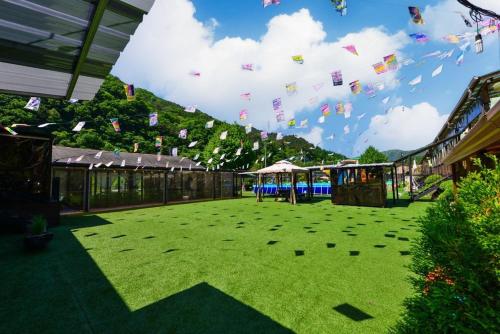 a large yard with flags flying in the sky at Dumil Play Kids Training Center in Gapyeong