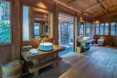 a bathroom with two sinks and two mirrors at Villa Kapungkur in Jimbaran