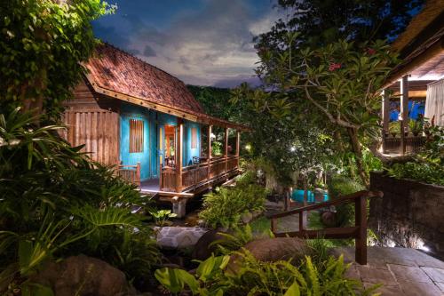 a house in the middle of a forest at night at Villa Kapungkur in Jimbaran
