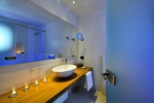 a bathroom with a bowl sink on a counter at Valeni Boutique Hotel & Spa in Portariá