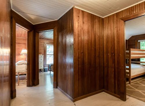 a room with wood paneled walls and a bedroom at Pavillion Paradise is Walking Distance to Lake Michigan in Holland
