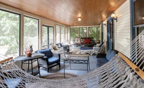 a screened porch with a hammock in a house at Pavillion Paradise is Walking Distance to Lake Michigan in Holland
