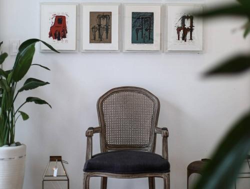 a chair in a room with pictures on the wall at Stay Jirisan Ahchim in Masal-li