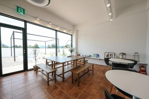 a room with tables and chairs and a large window at Stay Jirisan Ahchim in Masal-li