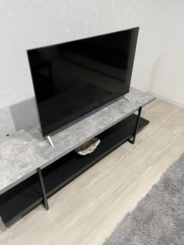 a flat screen tv sitting on a tv stand at Stellar西糀谷 301 in Tokyo