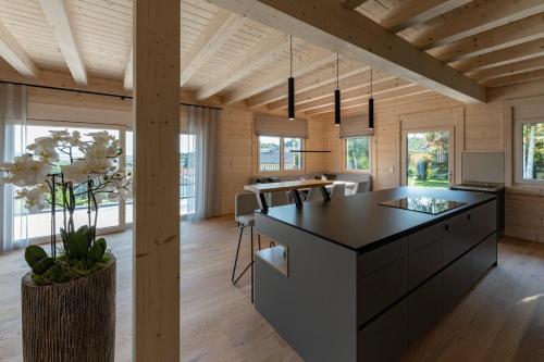 a kitchen with a black island in a wooden house at Chalet Kremstalblick in Neuhofen an der Krems