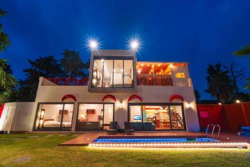 a house with a pool in front of it at night at Its you Pool Villa in Jeju