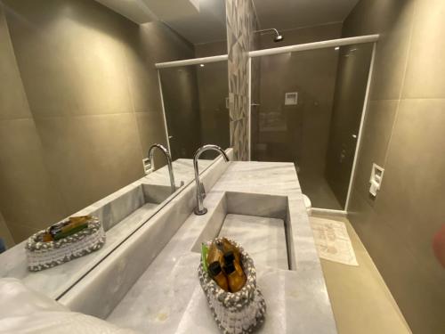 a bathroom with a sink and a mirror at Motel Caricia (Adult Only) in Rio de Janeiro