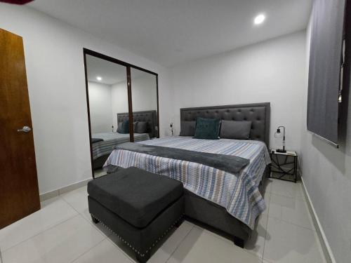 a bedroom with a bed and a large mirror at Reparto Metropolitano Apartments II in San Juan
