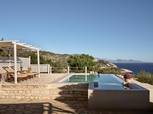 a swimming pool with a view of the ocean at Orfos Villas in Agios Nikolaos