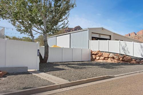a white fence in front of a house at The Silver Spur in Hildale