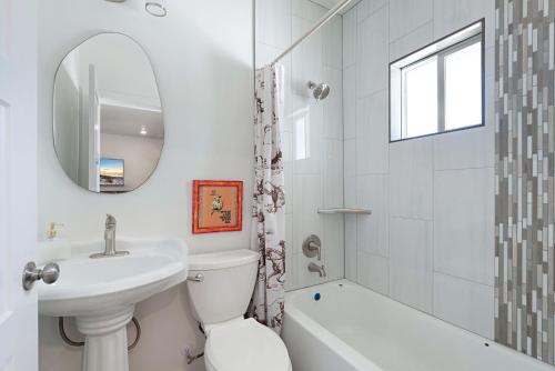 a white bathroom with a sink toilet and a mirror at The Silver Spur in Hildale