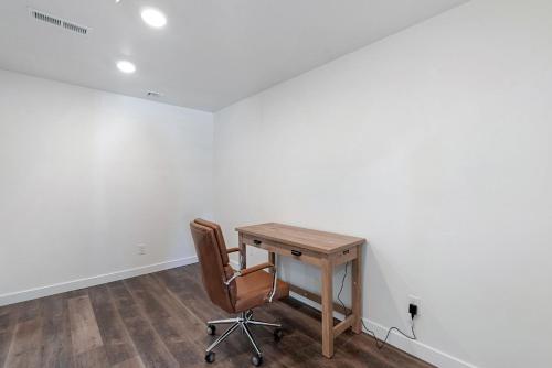 a desk and a chair in a room with white walls at The Silver Spur in Hildale