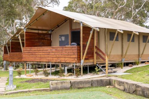 a house with a tent in a park at Reflections Bonny Hills - Holiday Park in Lake Cathie