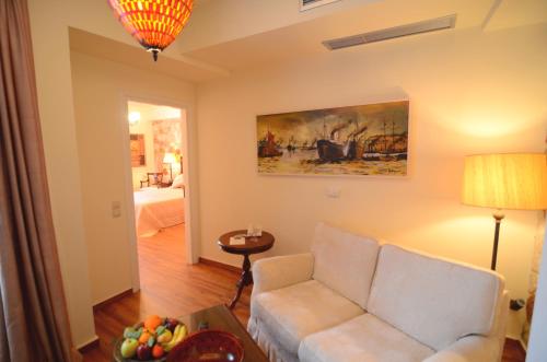 a living room with a couch and a table at Korina Gallery Hotel in Vathi, Ithaka