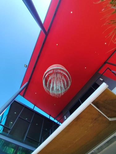 a red wall with a symbol on top of a building at O - HO Boutique Home in Baan Tai
