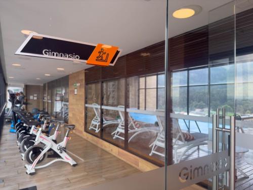 a gym with a row of treadmills and exercise bikes at Nuevo y Céntrico Apartamento in Bogotá