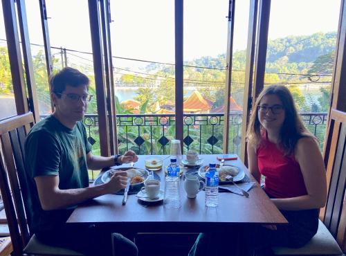 a man and a woman sitting at a table with food at Sesatha lake Kandy in Kandy