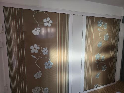a sliding glass door with flowers painted on it at Grand Baie Appartment Villa ii Cocotier in Grand Baie