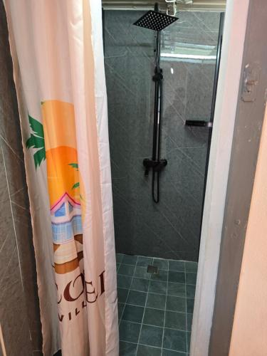 a shower with a shower curtain in a bathroom at Grand Baie Appartment Villa ii Cocotier in Grand Baie