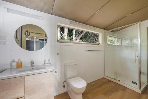 a bathroom with a toilet and a sink and a mirror at Reflections North Haven - Holiday Park in North Haven