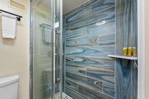 a shower with a glass door in a bathroom at 402 Kona Alii in Kailua-Kona