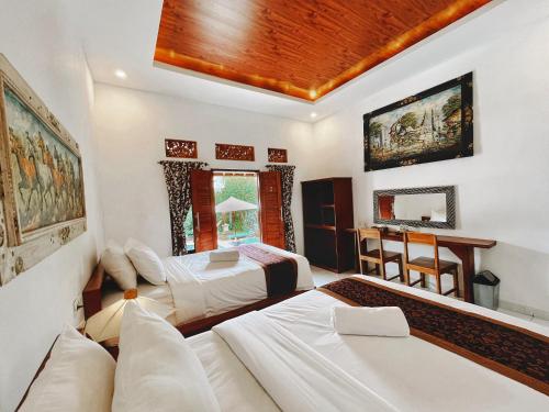 a living room with two beds and a couch at D'karang Eco Lodge in Undisan