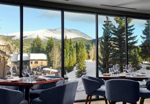 a dining room with a view of a snowy mountain at Hotel Alpenrock Breckenridge, Curio Collection by Hilton in Breckenridge