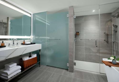 a bathroom with a glass shower and a sink at Hotel Alpenrock Breckenridge, Curio Collection by Hilton in Breckenridge