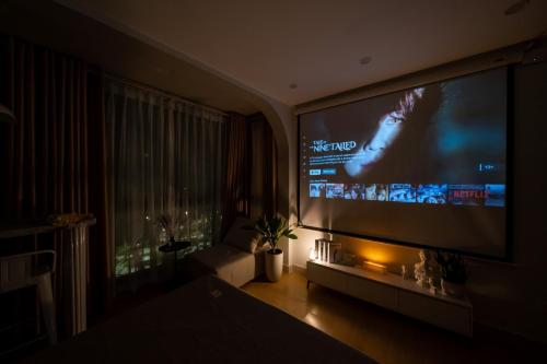 a living room with a large flat screen tv at Aimee House Homestay Trấn Vũ in Hanoi