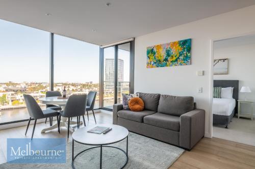 a living room with a couch and a table at Melbourne Private Apartments - Collins Wharf Waterfront, Docklands in Melbourne